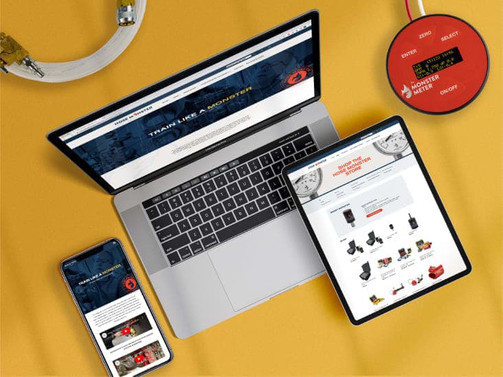 A laptop, phone and tablet displaying the Hose Monster website next to a Monster Meter gauge.